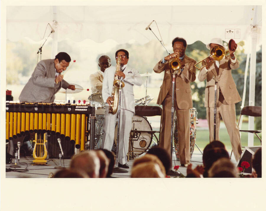 8 x 10 inch photograph. Lionel Hampton on vibraphone with Al Grey and other musicians at an outdoor concert at the White House. This concert was aired January 27, 1982 on the public television special, Great Vibes! Lionel Hampton and Friends, as part of the Kennedy Center Tonight series