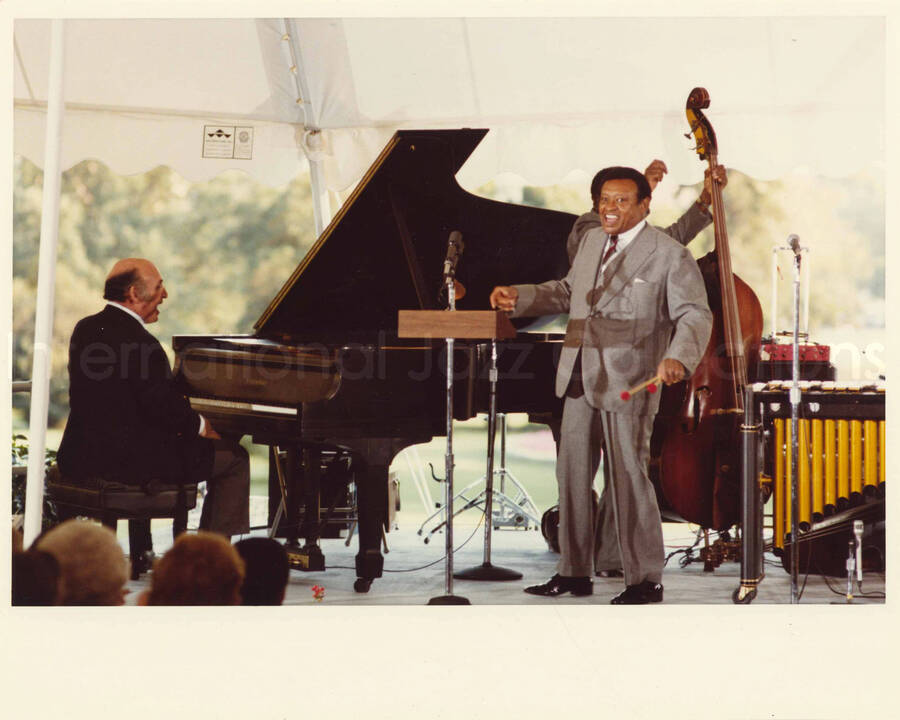 8 x 10 inch photograph. Lionel Hampton with unidentified pianist and others at an outdoor concert at the White House. This concert was aired January 27, 1982 on the public television special, Great Vibes! Lionel Hampton and Friends, as part of the Kennedy Center Tonight series