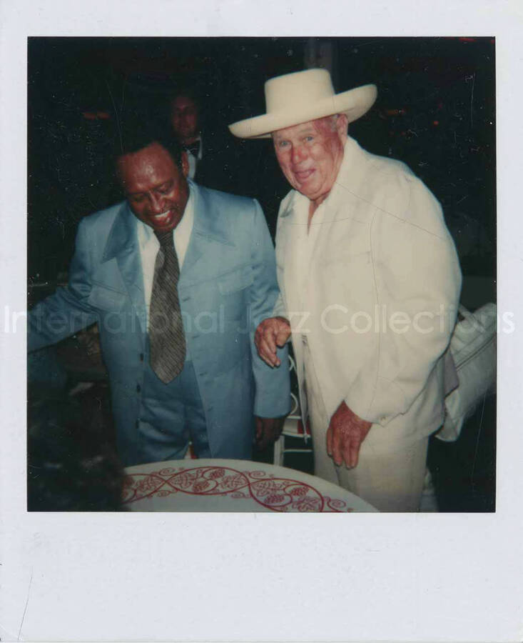 4 1/2 x 3 1/2 inch Polaroid photograph. Lionel Hampton with unidentified man [at Disneyland]