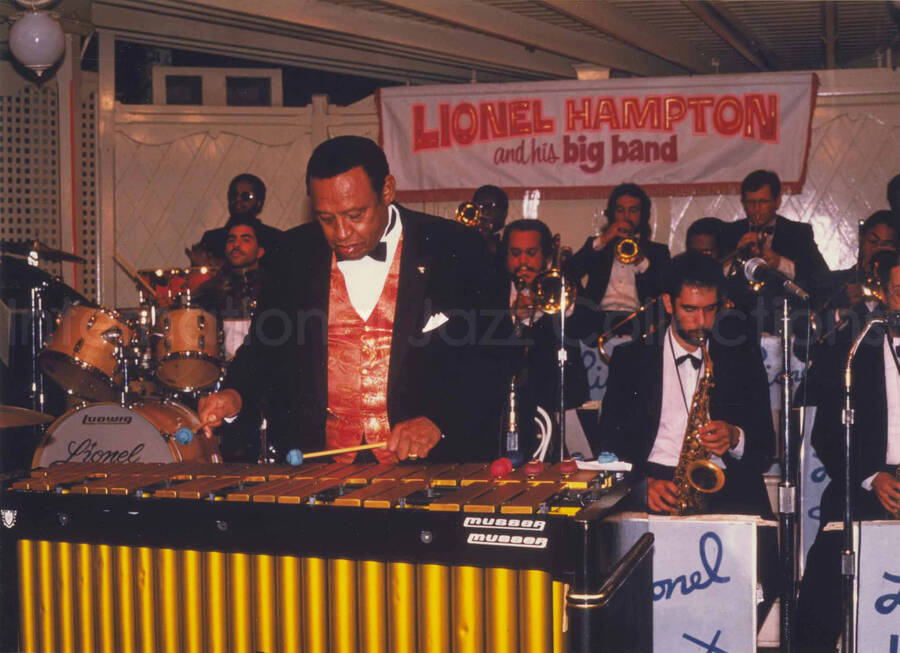 5 x 7 inch photograph. Lionel Hampton performing on the vibraphone with his Big Band [at Disneyland]