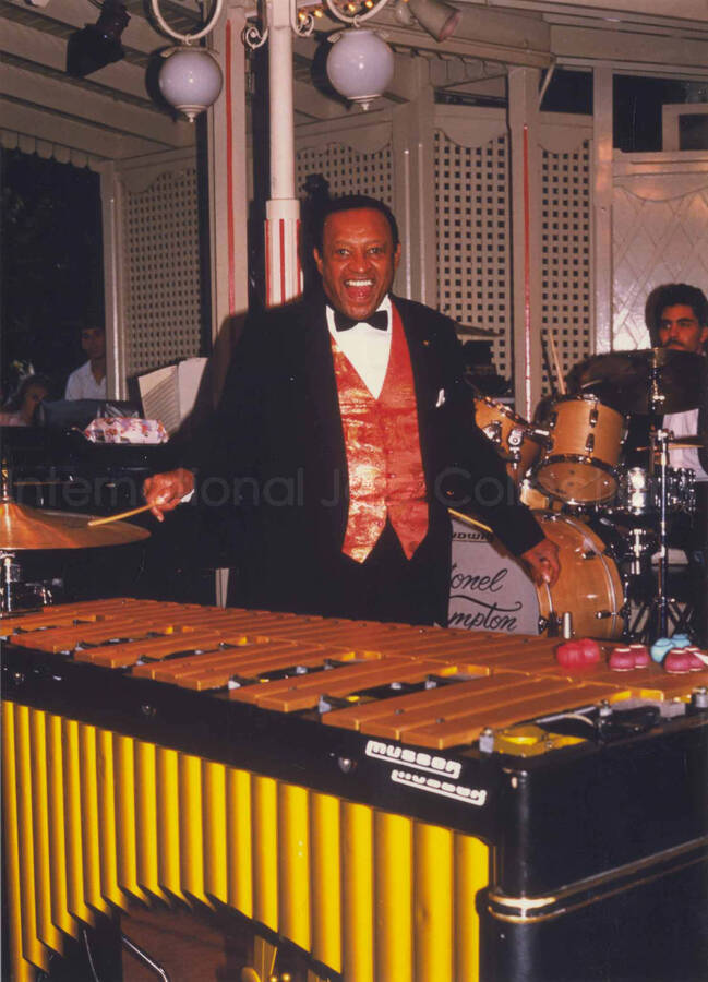 7 x 5 inch photograph. Lionel Hampton performing on the vibraphone with his Big Band [at Disneyland]