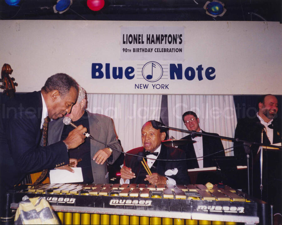 8 x 10 inch photograph. Lionel Hampton at the vibraphone with Bill Cosby and Tito Puente. Lionel Hampton's 90th birthday at the Blue Note in New York