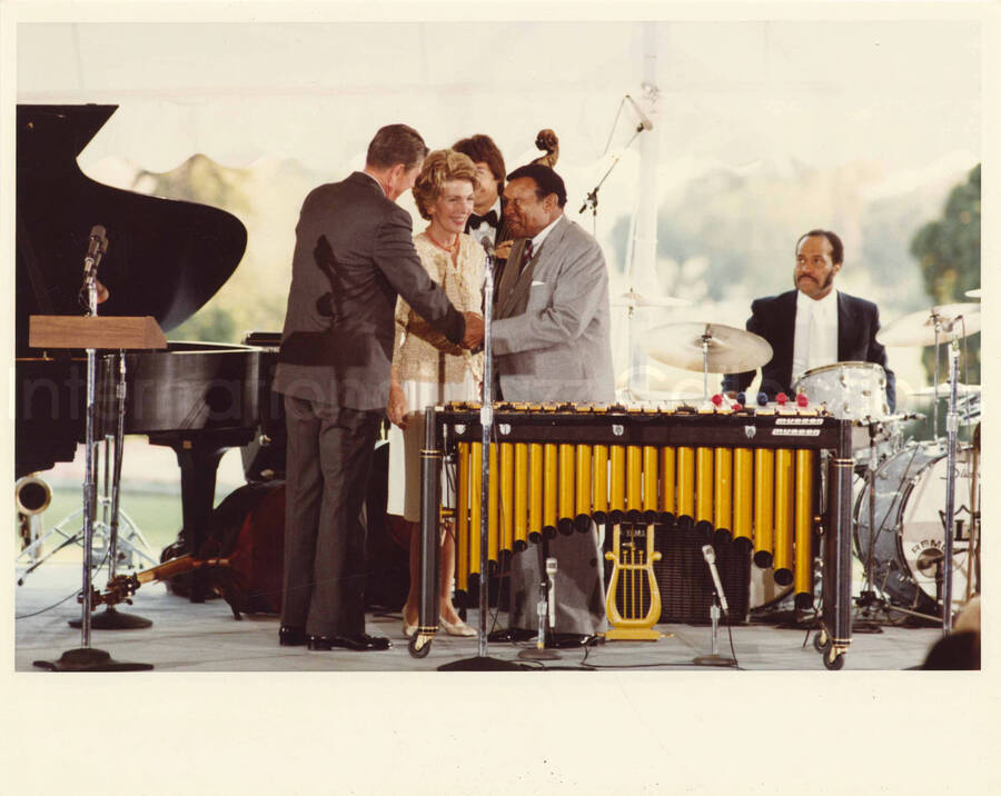 8 x 10 inch photograph. Lionel Hampton with President Ronald Reagan and First Lady Nancy Davis Reagan at an outdoor concert at the White House. This concert was aired January 27, 1982 on the public television special, Great Vibes! Lionel Hampton and Friends, as part of the Kennedy Center Tonight series
