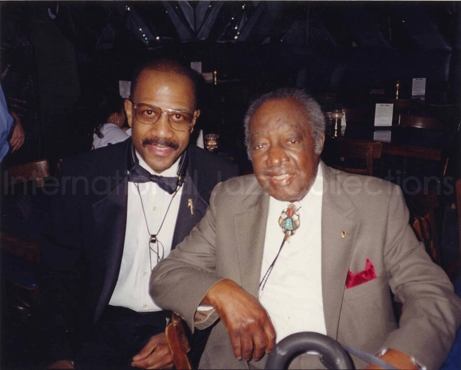 8 x 10 inch photograph. Judge Milt Hinton and unidentified man. Lionel Hampton's 90th birthday at the Blue Note in New York