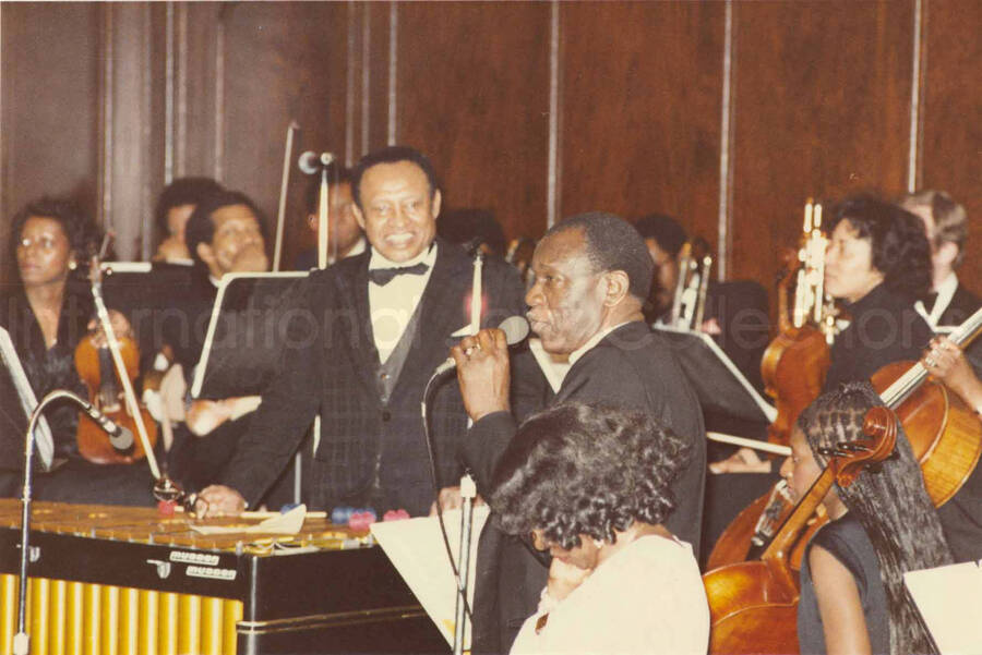 4 x 6 inch photograph. Lionel Hampton receives a plaque from the Mother African Methodist Episcopal Zion Church. Label on the back of the photograph reads: D. P. A. Syndicate, New York, NY