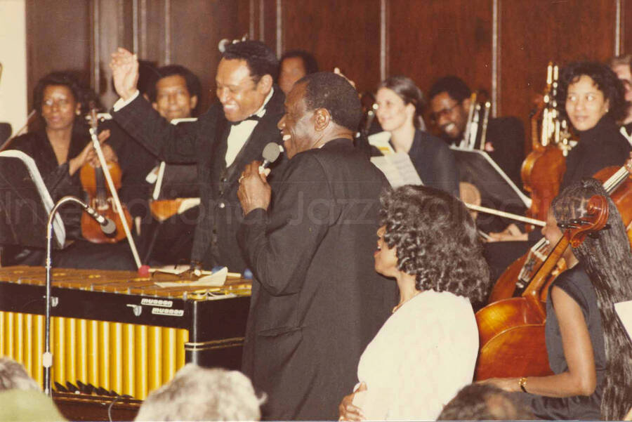 4 x 6 inch photograph. Lionel Hampton receives a plaque from the Mother African Methodist Episcopal Zion Church. Label on the back of the photograph reads: D. P. A. Syndicate, New York, NY