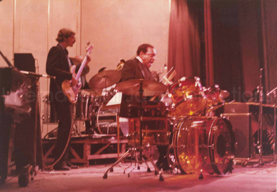 5 x 7 inch photograph. Lionel Hampton on drums with band. Handwritten on the back of the photograph: Teatro El Circulo, Rosario, Argentina; Lionel Hampton All Stars; Guy Mazzaroppi walking. This photograph has a dedication from Wis Contijoch and Ruben Gonzalez