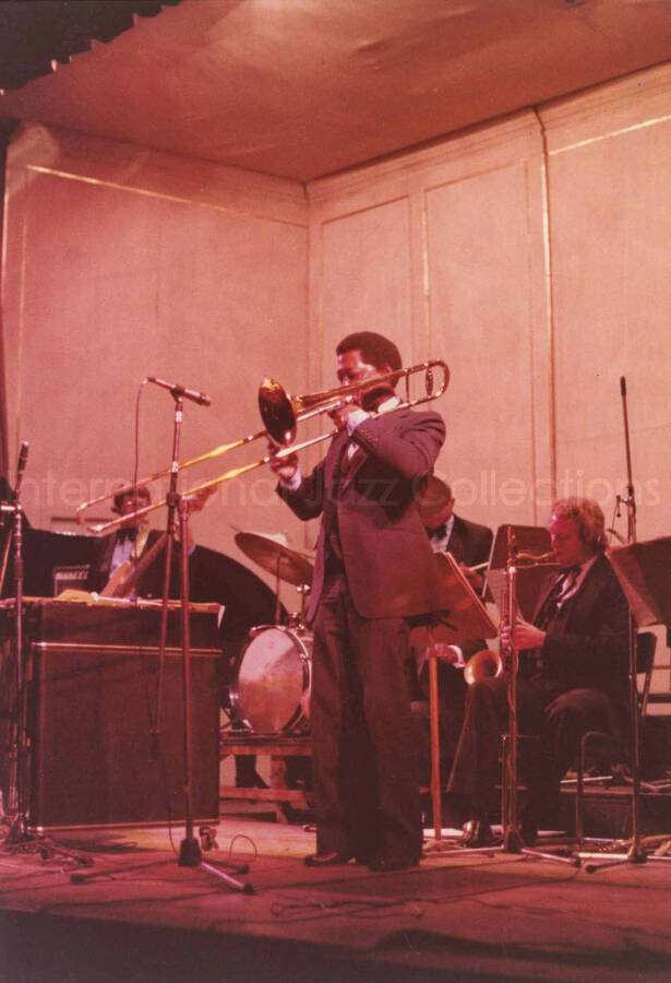 7 x 5 inch photograph. Lionel Hampton with band. Handwritten on the back of the photograph: Teatro El Circulo, Rosario, Argentina; Lionel Hampton All Stars; Curtis Fuller soloing. This photograph has a dedication from Wis Contijoch and Ruben Gonzalez