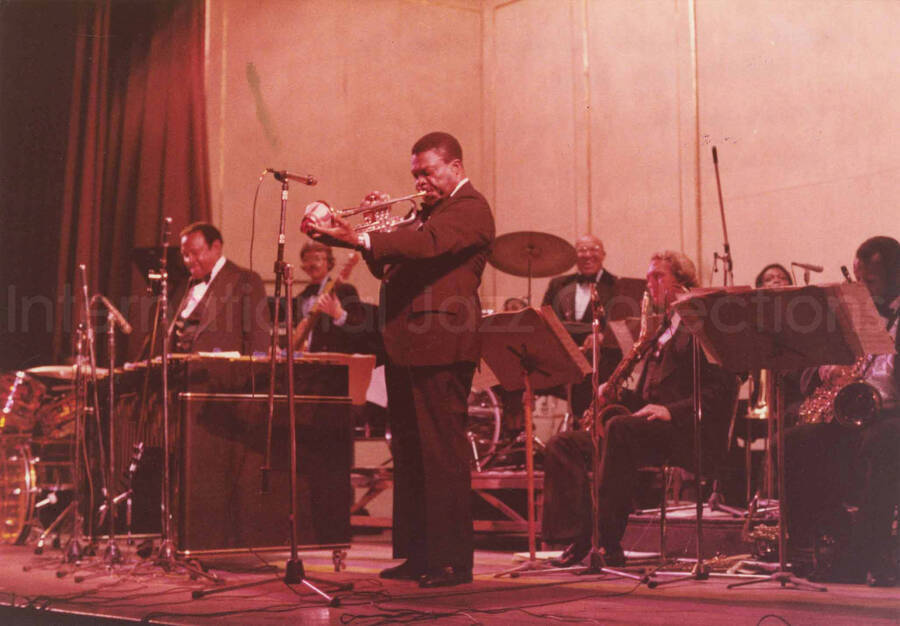 5 x 7 inch photograph. Lionel Hampton with band. Handwritten on the back of the photograph: Teatro El Circulo, Rosario, Argentina; Lionel Hampton All Stars; Cat Anderson soloing. This photograph has a dedication from Wis Contijoch and Ruben Gonzalez