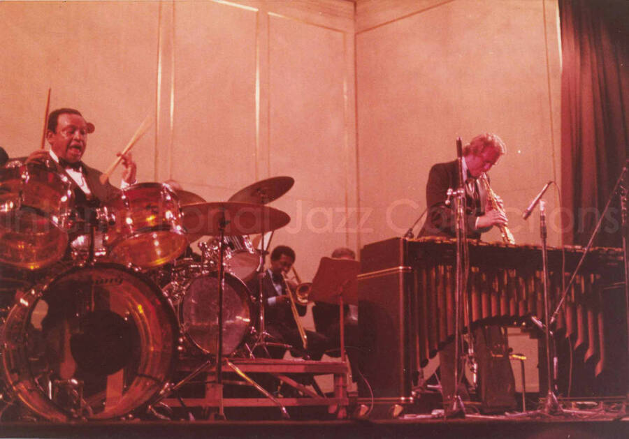 5 x 7 inch photograph. Lionel Hampton  on drums with band. Handwritten on the back of the photograph: Teatro El Circulo, Rosario, Argentina; Lionel Hampton All Stars; Paul Moen soloing. This photograph has a dedication from Wis Contijoch and Ruben Gonzalez