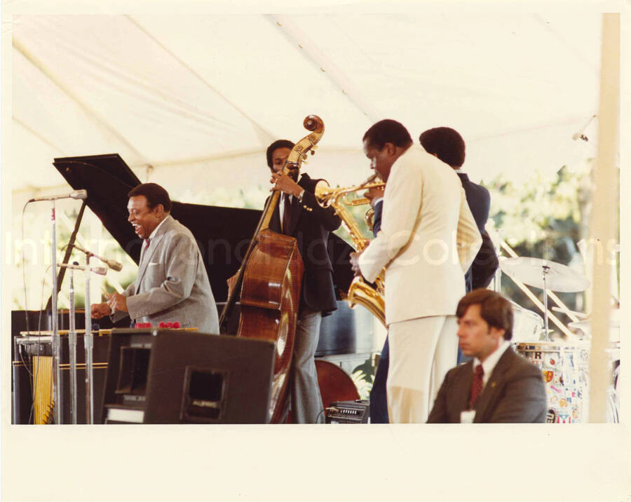 8 x 10 inch photograph. Lionel Hampton on vibraphone with other musicians at an outdoor concert at the White House. This concert was aired January 27, 1982 on the public television special, Great Vibes! Lionel Hampton and Friends, as part of the Kennedy Center Tonight series