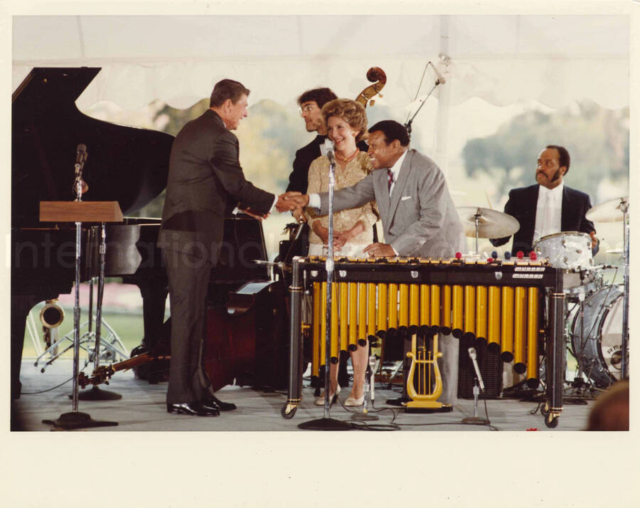 8 x 10 inch photograph. Lionel Hampton with President Ronald Reagan and First Lady Nancy Davis Reagan at an outdoor concert at the White House. This concert was aired January 27, 1982 on the public television special, Great Vibes! Lionel Hampton and Friends, as part of the Kennedy Center Tonight series