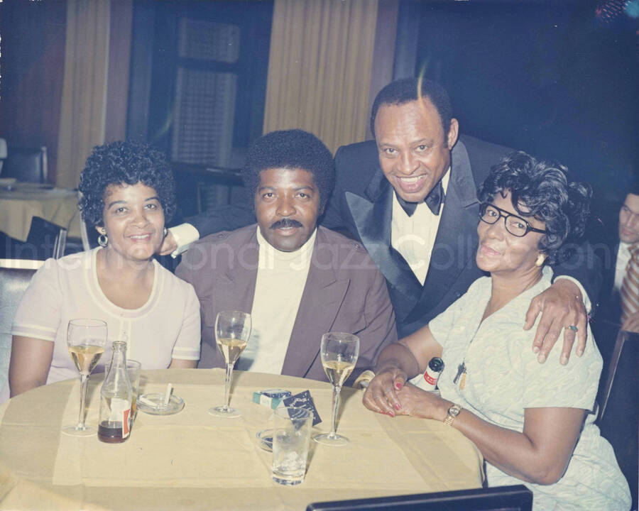 8 x 10 inch photograph. Lionel Hampton with unidentified persons at the Rainbow Grill Restaurant