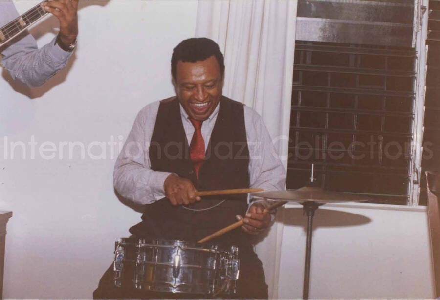 3 1/2 x 5 inch photograph. Lionel Hampton on drums at Bill Davis's home in Kingston, Jamaica