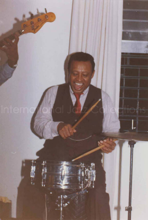 5 x 3 1/2 inch photograph. Lionel Hampton on drums at Bill Davis's home in Kingston, Jamaica