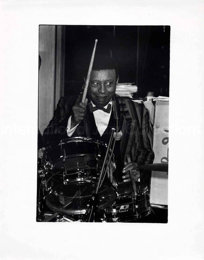 12 x 9 1/2 inch photograph. Lionel Hampton playing the drums [in France?]