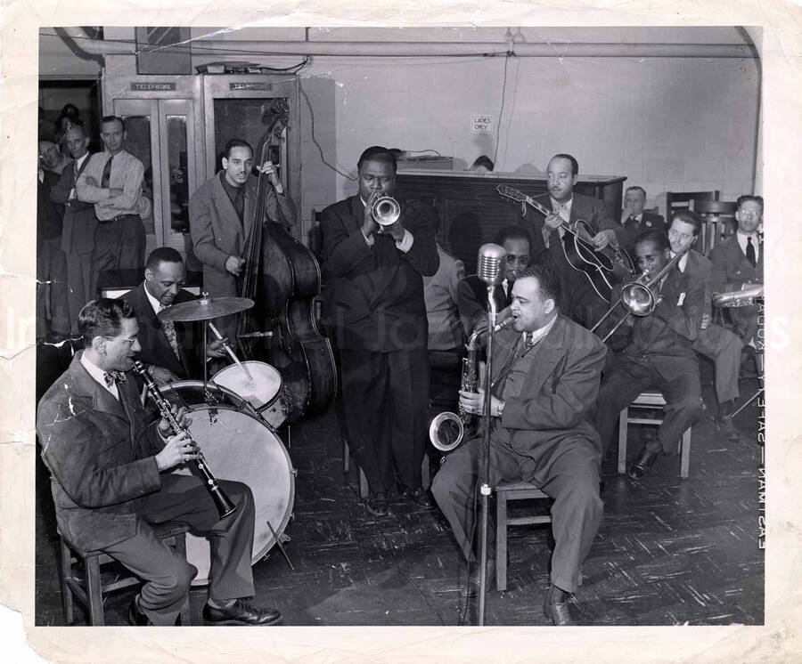 9 1/2 x 11 inch photograph. Lionel Hampton on drums with band, which includes guitarist Billy Mackel