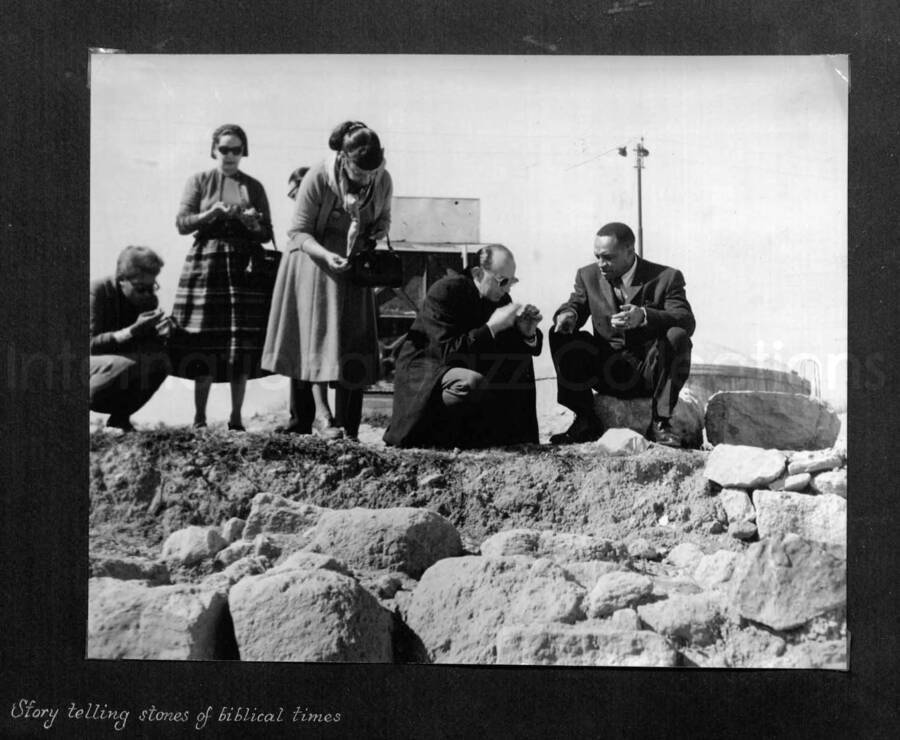 10 x 10 inch photograph. Lionel Hampton in Israel. This photograph is in a photo album titled: In the Holy City - Jerusalem. Caption under the photograph reads: Story telling stones of biblical times