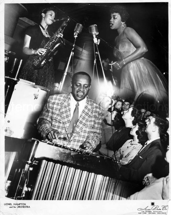14 x 11 1/4 inch promotional photograph. This is a combination of images depicting Lionel Hampton playing the vibraphone, unidentified saxophonist and vocalist, and audience