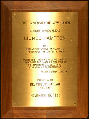 Plaque. 12"x9" Wood finish plaque with engraved plate To Lionel Hampton from the University of New Haven for performing chords of goodwill throughout the United States. Phillip Kaplan, President. Nov. 19, 1981. (With a quote from Martin Luther King, Jr.)