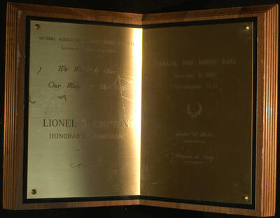 Plaque. 11"x16" Book wood finish plaque with engraved double plate To Lionel Hampton, Honorary Chairman, from the National Association of Black Women Attorneys Scholarship Fund Committee on the occasion of the Annual Red Dress Ball. Mabel D. Haden, Chairperson and Leronia A. Josey, President. Washington, D.C., Feb. 8, 1985