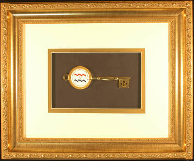 Key to the City Plaque.  17 1/2"x14 1/2" Wood frame holding a 6" ceremonial key on black background in double mat. The key bears the city and mayor's names on a white enameled central disc on the bow and a tooth that features a fleur-de-lis design Ceremonial key to the City of New Orleans presented to Lionel Hampton. Marc H. Morial, Mayor. New Orleans, LA