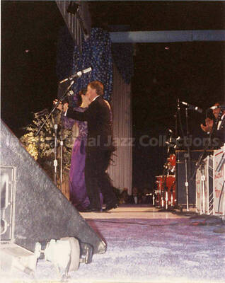 4 1/2 x 3 1/2 inch photograph. Dan and Marilyn Quayle, dancing on stage in front of Lionel Hampton's orchestra, on the occasion of President George H. W. Bush's Inaugural Ball