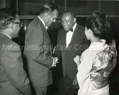 8 x 10 inch photograph. Lionel Hampton with unidentified persons, including a woman dressed in Japanese costume [Yukari Kuroda?]