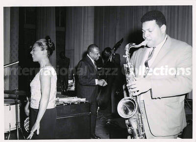 5 x 7 inch photograph. Cannonball Adderley, unidentified singer, and Lionel Hampton, on the occasion Hampton received the Certificate of Distinguished Honorary Alumnus from Langston University. Langston, OK