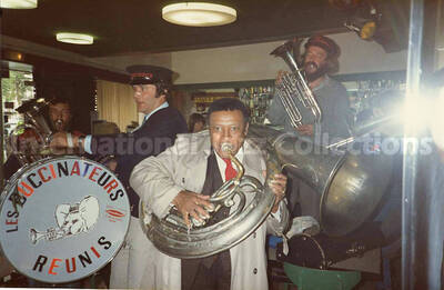 3 1/2 x 5 1/2 inch photograph. Lionel Hampton with the band Les Buccinateurs Reunis in a restaurant in [Bordeaux], France