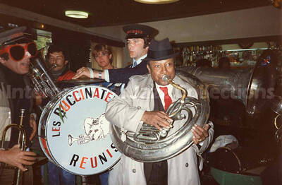 3 1/2 x 5 1/2 inch photograph. Lionel Hampton with the band Les Buccinateurs Reunis in a restaurant in [Bordeaux], France