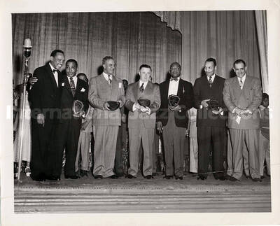 8 x 10 inch photograph. Lionel Hampton with unidentified men holding plaques
