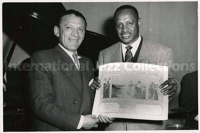 5 x 7 1/2 inch photograph. Lionel Hampton receiving the certificate from the Golden Book of the Jewish National Fund, upon the completion of a series of performances for the benefit of the Magen David Adom Fund in Israel