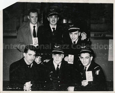 8 x 10 inch photograph. [U.S. Air Force personnel] holding photographs of Lionel Hampton