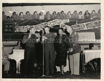8 x 10 inch photograph. Lionel Hampton with unidentified woman and two men. On the men's shoulder is the AA patch of the 82nd Airborne division