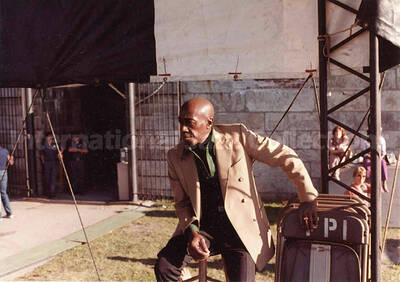 3 1/2 x 5 inch photograph. Unidentified man. Printed on the back of a chair: FPI