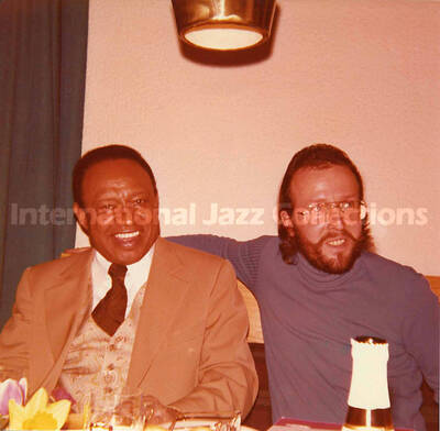 5 x 5 inch photograph. Lionel Hampton and Jean Claude Forestier in a restaurant
