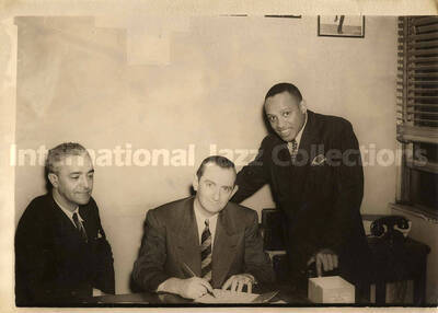 5 x 7 inch photograph. Lionel Hampton with [Joe Glaser?] and an unidentified man