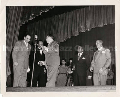 8 x 10 inch photograph. Lionel Hampton with unidentified men holding plaques