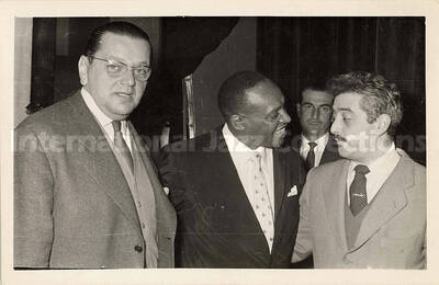 4 1/2 x 7 3/4 inch photograph. Lionel Hampton with unidentified men