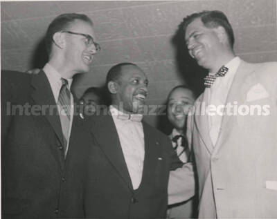 8 x 10 inch photograph. Lionel Hampton with unidentified men