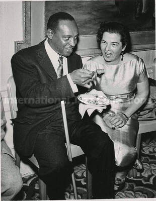 5 x 3 1/2 inch photograph. Lionel Hampton poses with a member of the Los Angeles Chapter of Hadassah, on the occasion of his being awarded the certificate of the Hadassah Vocational Education Scholarship for his devotion to the State of Israel. Los Angeles, CA