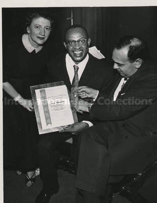 5 x 3 1/2 inch photograph. Lionel Hampton holding a plaque poses with members of the Los Angeles Chapter of Hadassah, on the occasion of his being awarded the certificate of the Hadassah Vocational Education Scholarship for his devotion to the State of Israel. Los Angeles, CA
