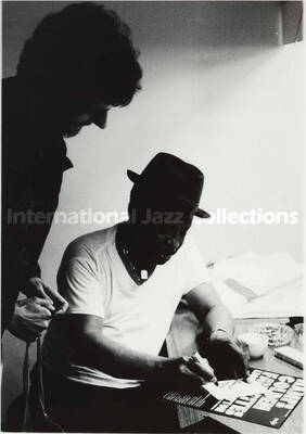 10 x 8 inch photograph. Lionel Hampton signs a copy of his record Hamps Golden Favorites