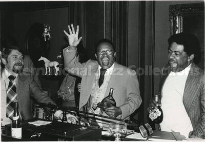 8 x 10 inch photograph. Lionel Hampton, Dizzy Gillespie, and an unidentified man