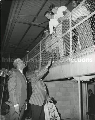 10 x 8 inch photograph. Lionel Hampton with Government Secretary. Hampton is holding a bag that reads: Virgin Islands