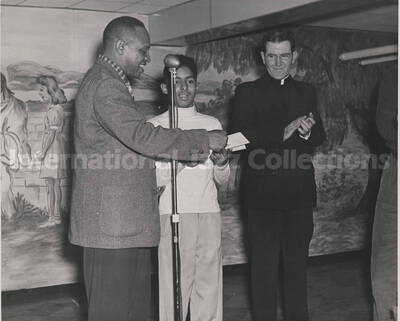 8 x 10 inch photograph. Lionel Hampton with unidentified boy and religious person