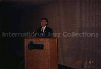4 x 6 inch photograph. Unidentified man on podium on the occasion of the dedication of the Lionel Hampton School of Music. University of Idaho, Moscow, ID