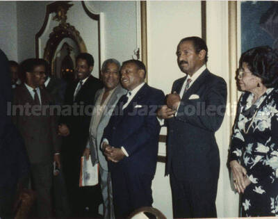 4 x 5 inch photograph. Lionel Hampton with unidentified musicians at a reception