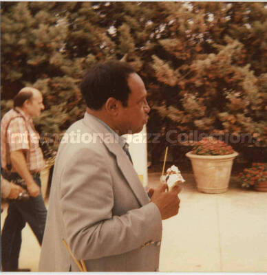 3 1/2 x 3 1/2 inch photograph. Lionel Hampton walking in a marine mammal park